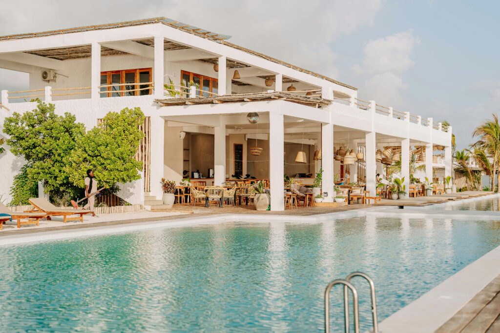 Modern beachfront resort with pool in Jambiani, Tanzania, showcasing tropical luxury and relaxation.